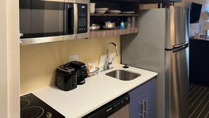 A compact kitchen with a microwave, toaster, coffee maker, sink, and dishwasher. - MainStay Suites Ozona I-10 (Ozona)