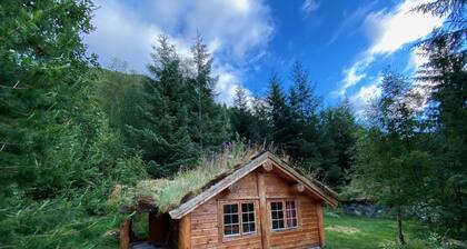Wooden cabin with grass roof, sleeps 2-5 people., Self catering. Open fire place