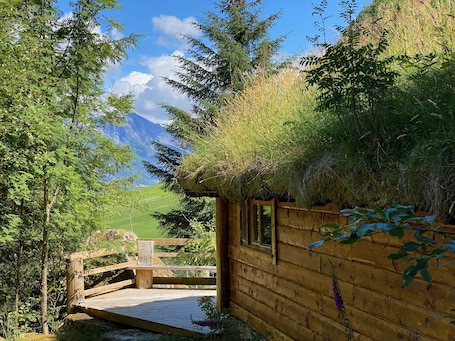 Terrace/patio. Wooden cabin with grass roof, sleeps 2-5 people., Self catering. Open fire place