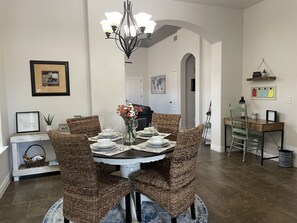 Enjoy meals with family and friends in this cozy dining area, complete with a round table and comfortable seating for four.