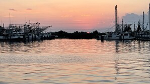 A marina with boats docked, calm water, and a sunset in the background. - 6 MAN BEER CAN VENICE MARINA FRONT ROW ICE, WIFI, & W/D GREAT CAMP (Venice)