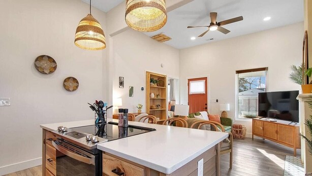 A modern kitchen with a central island, wooden cabinetry, and pendant lighting. - This townhouse is a 1 bedroom(s), 1 bathrooms, located in Wichita, KS. (Wichita)