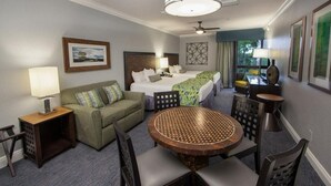 A hotel room with a bed, a sofa, a round dining table, and a ceiling fan. - Holiday Inn Vacation club Orange Lake (Kissimmee)