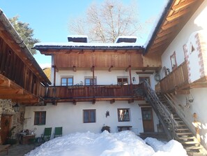 A traditional chalet with a wooden balcony, a staircase, and a snow-covered ground. - Fantastic opportunities to experience a varied holiday!
Historical Guest House  (Lajen)