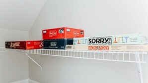 A shelf with various board games including Scrabble, Monopoly, and Sorry! - Ridgeview Retreat: Mountain Views and Pet Friendly (Staunton)