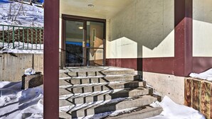 A building entrance with concrete steps leading up to a glass door. - Walkable Lead Condo: 5 Mi to Terry Peak Ski Area! (Lead)