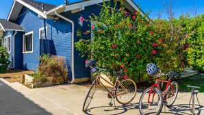 A bicycle parked in front of a blue house with a garden. - House in Prime Belmont Heights Near Beach w/ Gym and Garage (Long Beach)
