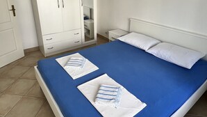 A bedroom with a bed, white wardrobe, and a nightstand. - Villa Irmica - Impressive pool, spacious apartment (86 m²) - first floor (Donja Jagodnja)