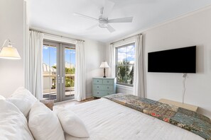 A bedroom with a bed, a dresser, a television, and a balcony with curtains. - Beach Views, Private Pool, Recently Remodeled - Steps to the Beach! (Santa Rosa Beach)