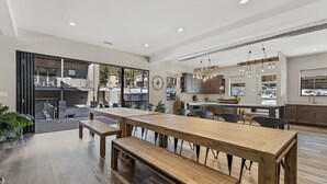 A spacious kitchen with a large island, wooden flooring, and modern lighting fixtures. - "The Spruce"-Gathering Tree is your Ultimate Family Reunion Spot (Flagstaff)