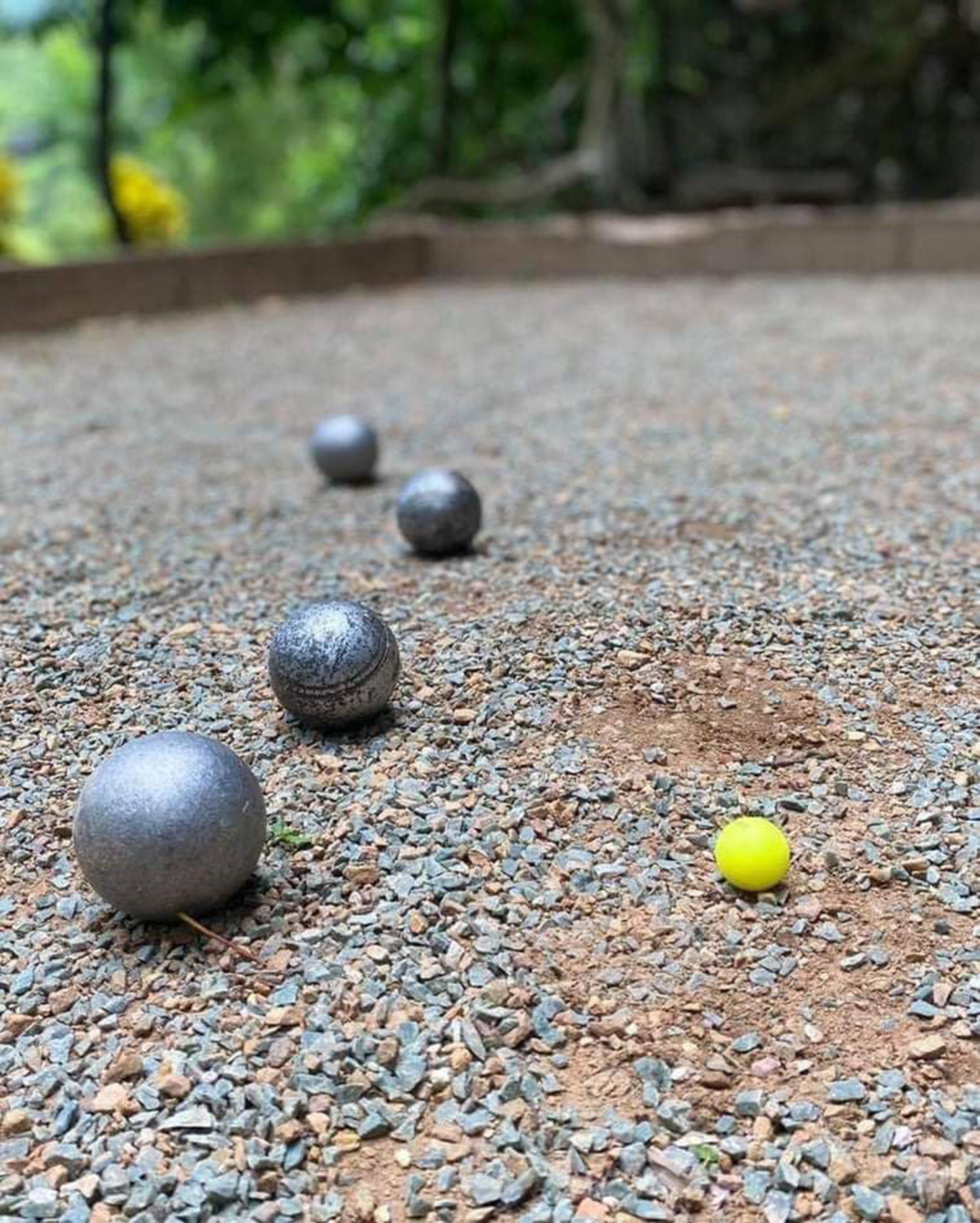 A gravel path with several spherical objects.
