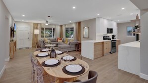 Eine moderne Wohnung mit Essbereich, Wohnzimmer und Küche.