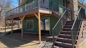 A two-story building with a balcony and a stone exterior. - Stunning views on tranquil lake. (Crosslake)