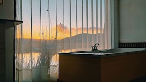 A bathroom with a wooden vanity and a sink. - Titicaca Los Uros vanalux (Puno)