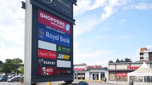 A large signboard with various store names including Royal Bank, Subway, and KFC. - Cozy King Sized Private Entrance Suite 15 min from YVR and self check in (Richmond)