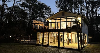 Cozy coastal oasis w/ wooded views and wrap around deck. Close to Dauphin Island