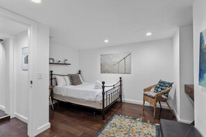 A bedroom with a bed, a chair, a painting, and a small table. - Boise-Westend-hot tub-Central location 4 bedrooms (Boise)
