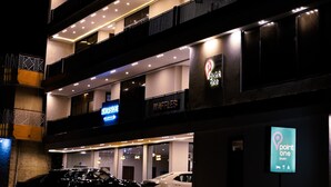 A multi-story building with illuminated balconies and a sign for "point one" hotel. - Point One (Swat)