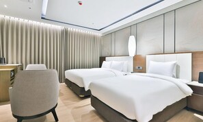 A hotel room with two beds, a desk, a chair, and a large window with curtains. - Daegu Billion Western Hotel (Daegu)