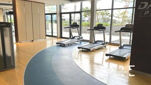 A modern gym with treadmills, a stationary bike, and a weight machine.