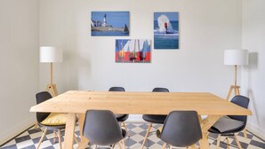 A conference room with a wooden table, black chairs, and two floor lamps. - Charming town house completely renovated (Quimper)