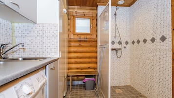 A compact kitchen with a sink, cabinets, and a window.