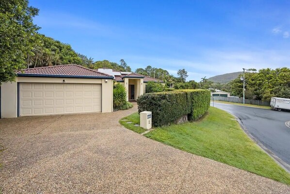 A residential property with a garage, a driveway, and a well-maintained lawn.