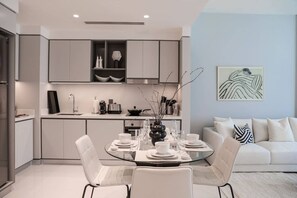 Enjoy meals with family and friends in this stylish dining area, complete with a glass-top table and comfortable seating for four.