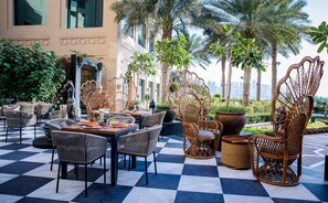 Enjoy dining al fresco amidst lush greenery and a beautifully maintained outdoor setting.
