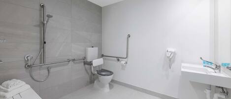 Un baño moderno con inodoro, ducha y lavabo.