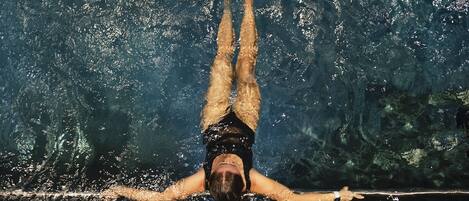 A person swimming in a pool.