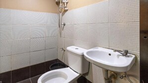 A bathroom with a toilet, bidet, and sink, all with white fixtures. - Casa Venicia Caticlan (Boracay Island)