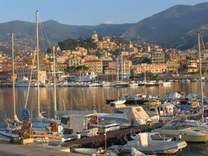 A marina with boats docked, a cityscape in the background, and mountains. - Cristina Home "Downtown" (Sanremo)