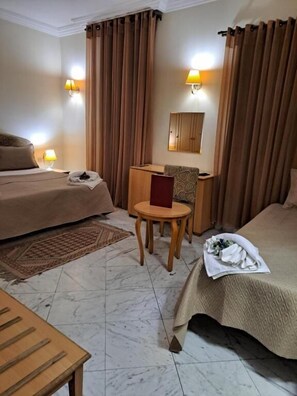 Triple Room | Minibar, in-room safe, blackout drapes, iron/ironing board