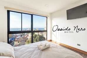 Habitación Deluxe doble, 1 cama doble, vistas al mar | Caja fuerte, wifi, ropa de cama