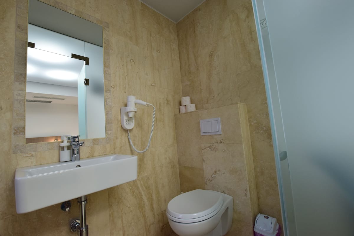 Ein Badezimmer mit Waschbecken, Toilette und Spiegel.
