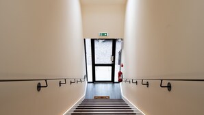 A modern staircase with wooden steps and a skylight at the top. - Loch Ness Gate House (Fort Augustus)