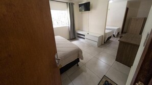 A bedroom with a bed, a TV mounted on the wall, and a wardrobe. - Nacional Park Hotel Lages (Lages)