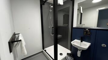 Shower, designer toiletries, hair dryer, towels