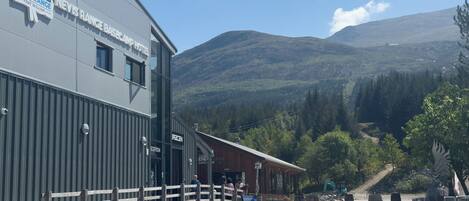 A hotel named Nevis Range with a mountain backdrop.