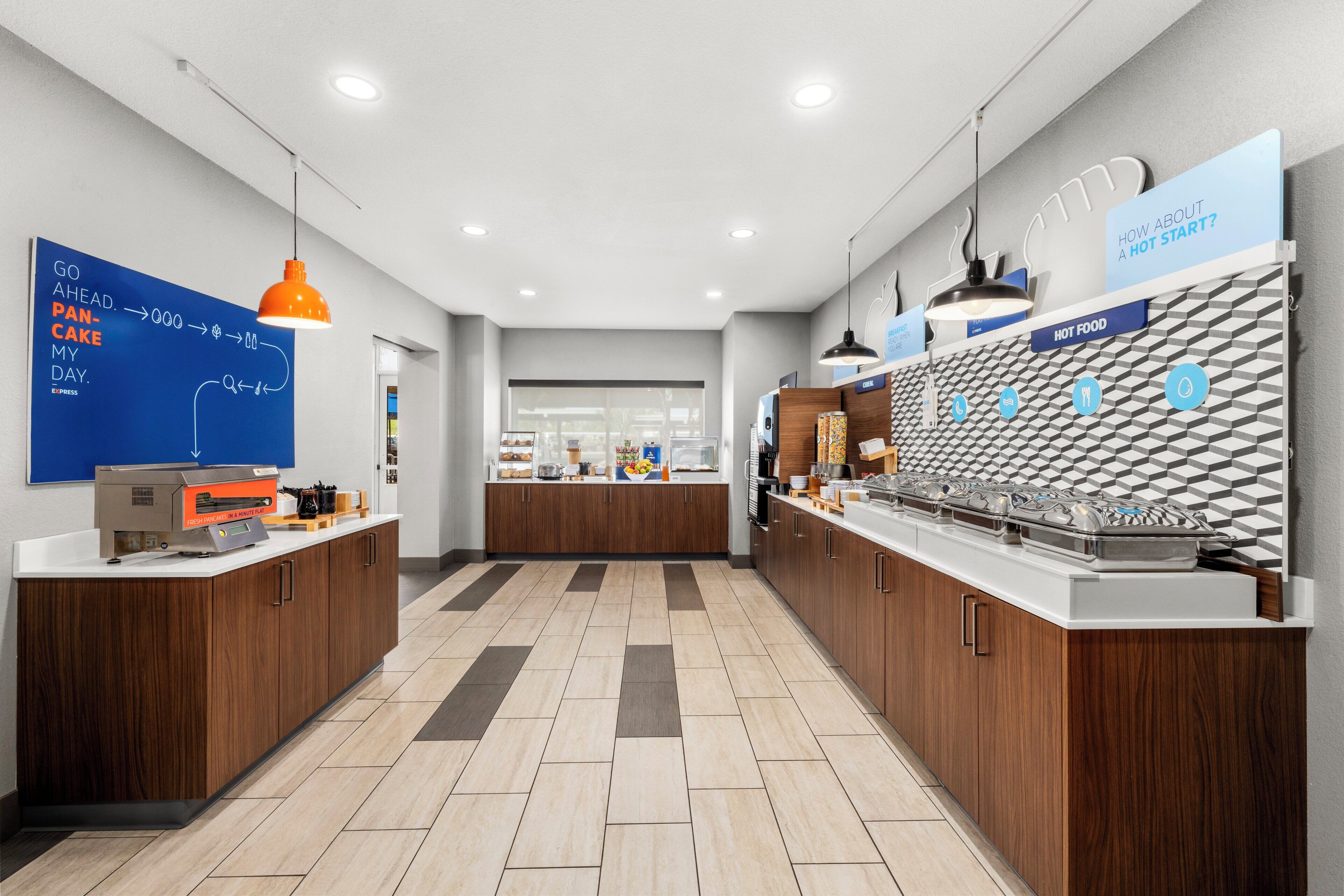 A modern kitchen with wooden cabinets, a central island, and a patterned backsplash.