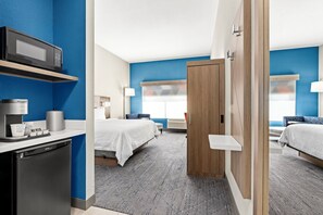 A modern hotel room with a kitchenette, a bed, a desk, and a bathroom. - Holiday Inn Express & Suites Phoenix West Tolleson by IHG (Phoenix)