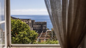 A view from a window overlooking a coastal area with buildings and a clear sky. - Dubrovnik Old Town Apartments (Dubrovnik)