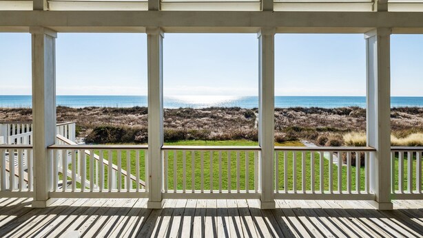 A wooden deck with white railings overlooking a beach and grassy dunes. - Blount Cottage-Oceanfront, Pet Friendly Home in Atlantic Beach, NC (Atlantic Beach)