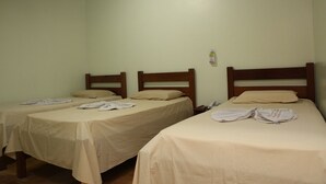 Two single beds with wooden headboards in a room with plain walls and a wooden ceiling. - Tibiriçá Hotel LTDA (Maraba)