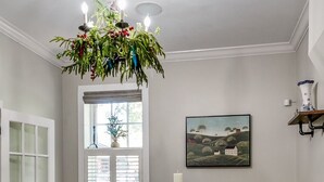 A dining room with a chandelier, a table set for four, and a window with blinds. - Historic headquarters of city founder! Gated parking! (Saint Charles)