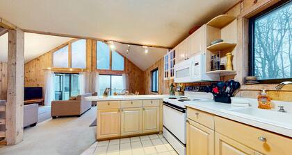 Charming home with fireplace, game room, full kitchen, gas grill, & balcony