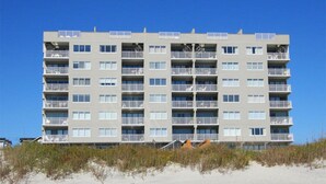 A multi-story hotel with balconies, located near a beach. - Carolina Dunes 502 2BR OF Condo in Cherry Grove (North Myrtle Beach)