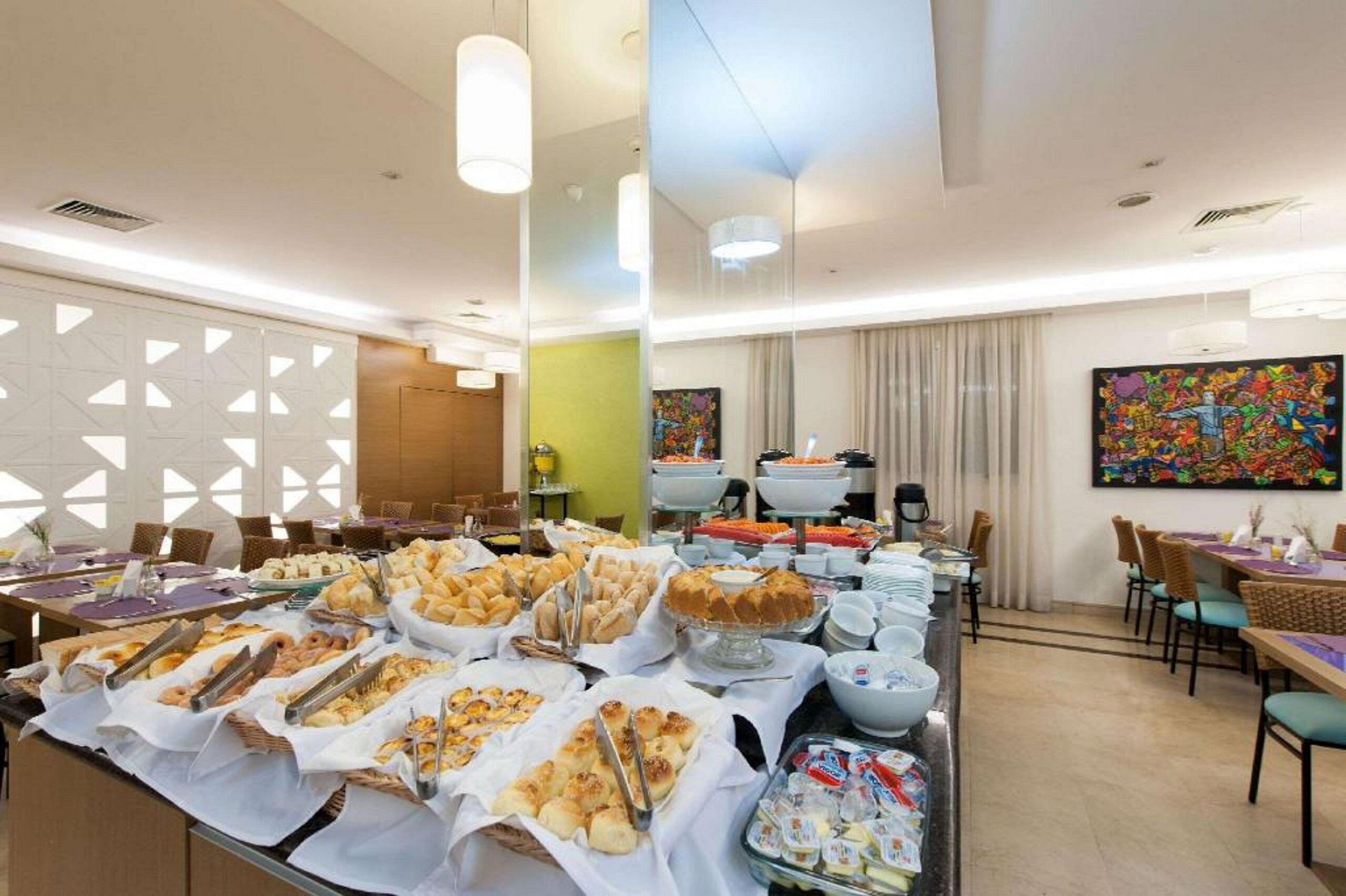 A buffet area with various food items and dining tables.