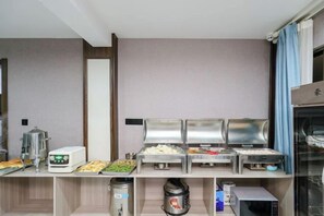 A buffet setup with various food items and a coffee machine. - Ruixi International Hotel (Guang'an Railway Station Branch) (Guang'an)